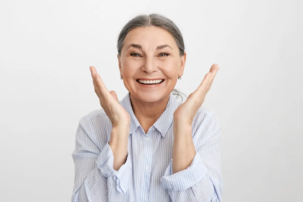 Happy senior patient with a confident full-arch implant smile after care at MAP Dental Center Houston.